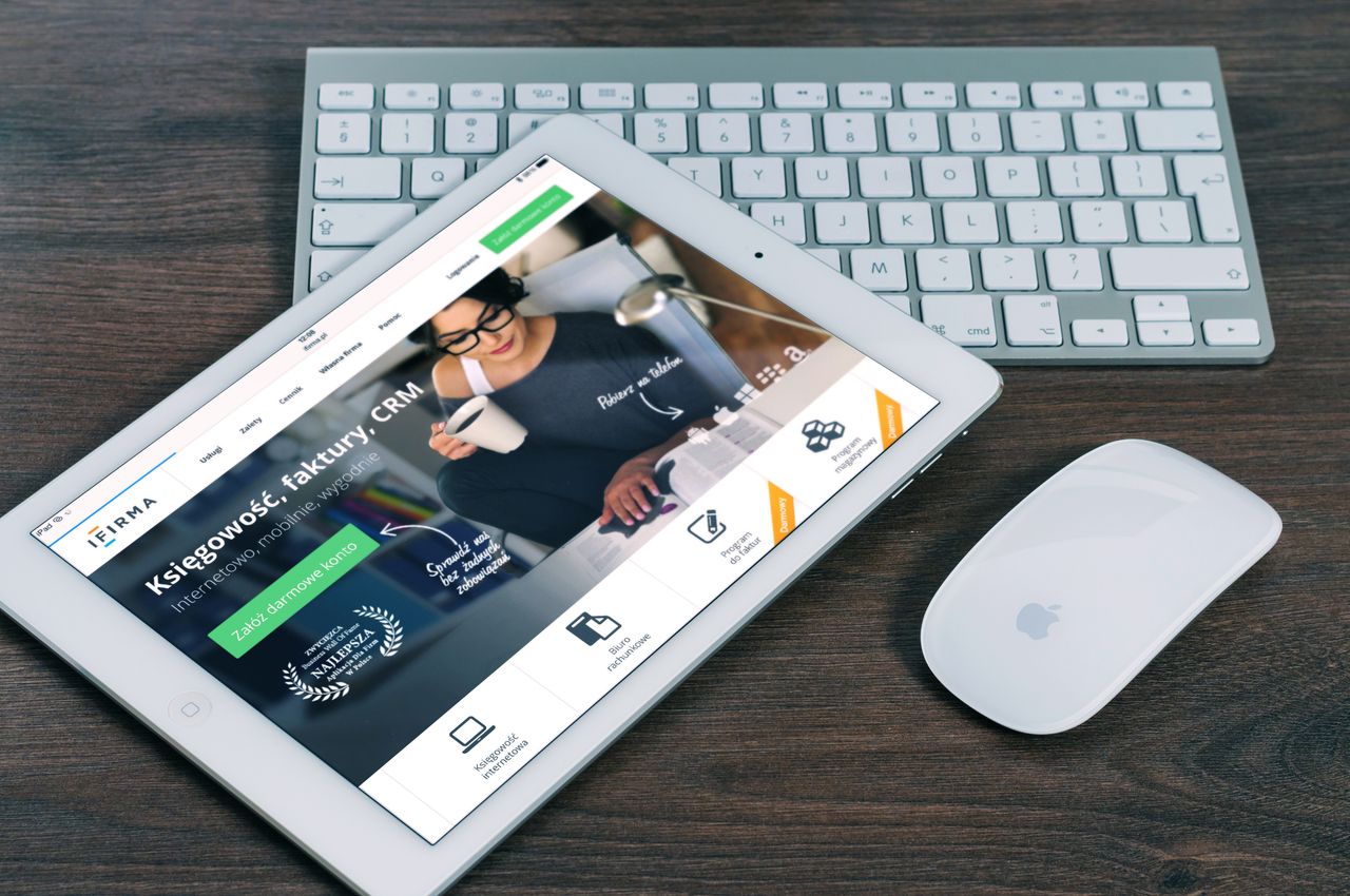Services A tablet with a financial website open, alongside a white keyboard and mouse. Ideal for tech-theme stock images.